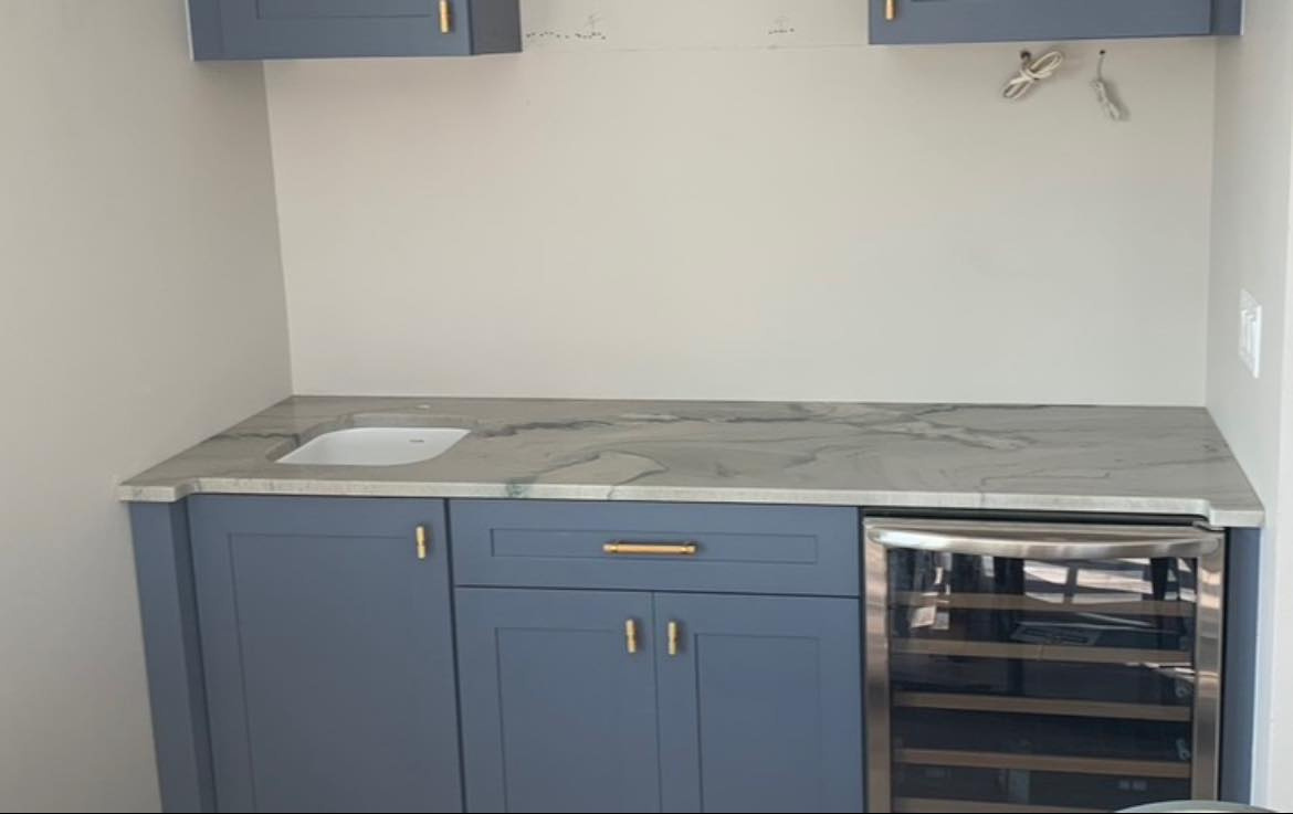 melbourne fl granite countertops a kitchen with blue cabinets and marble counter tops