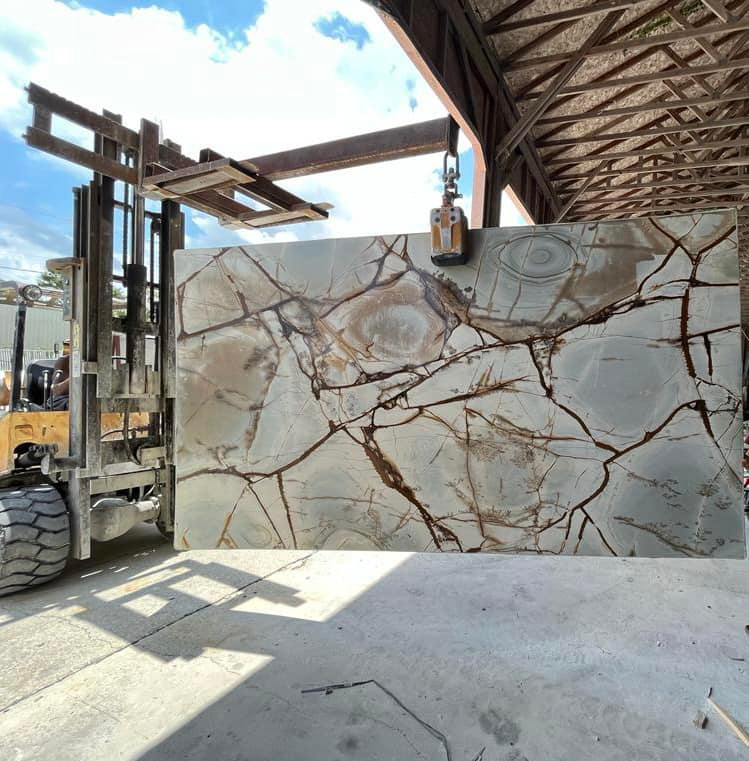 melbourne fl granite countertops a large slab of marble is being loaded onto a forklift